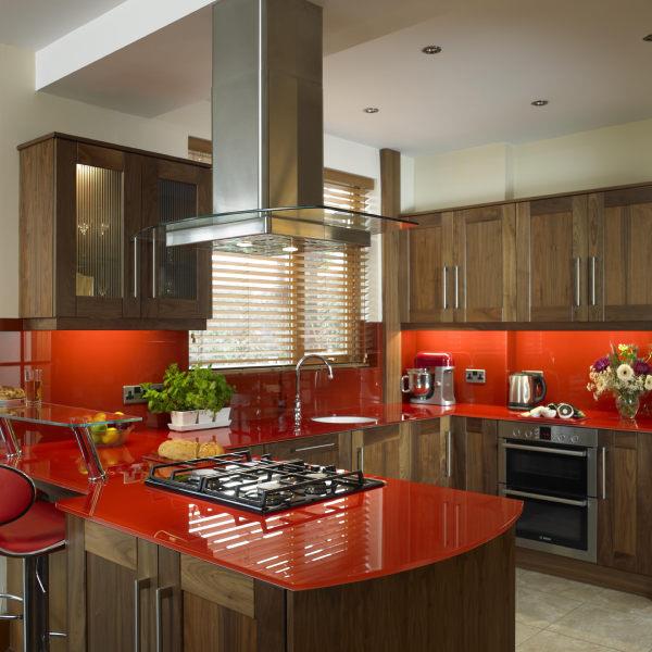 As featured in Beautiful Kitchens Magazine. Our customer chose to have our bespoke 15mm toughened optiwhite worktops and 6mm toughened optiwhite splashbacks to add a 'touch of glass' to their kitchen. Colour: Dulux Hot Paprika