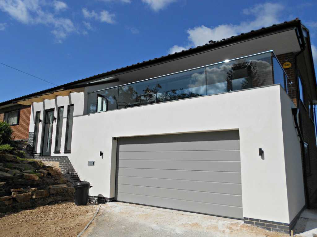 15mm toughened heat soaked glass balustrade into structural aluminium channel with polished stainless steel posts.