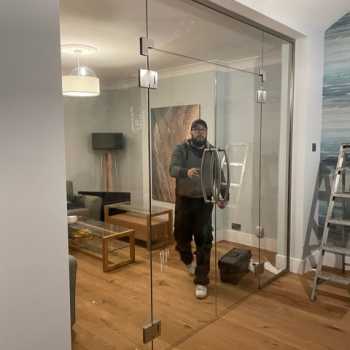 Glass fitter installing glass door in Nottingham