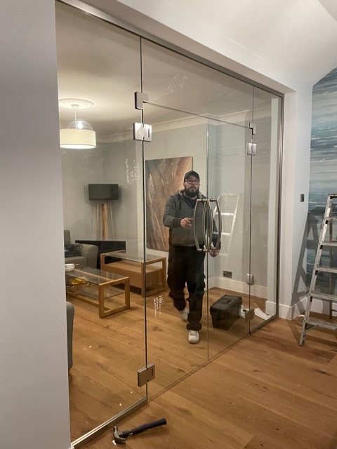 Glass fitter installing glass door in Nottingham